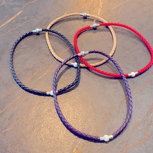 Bundle of 4 choker pearl and vegan leather necklaces. Marked 925 next to pearl.